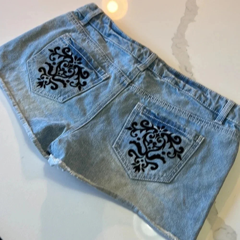 Material Girl light wash jean shorts with black velvet embellishments. Size 7 - Picture 5 of 9